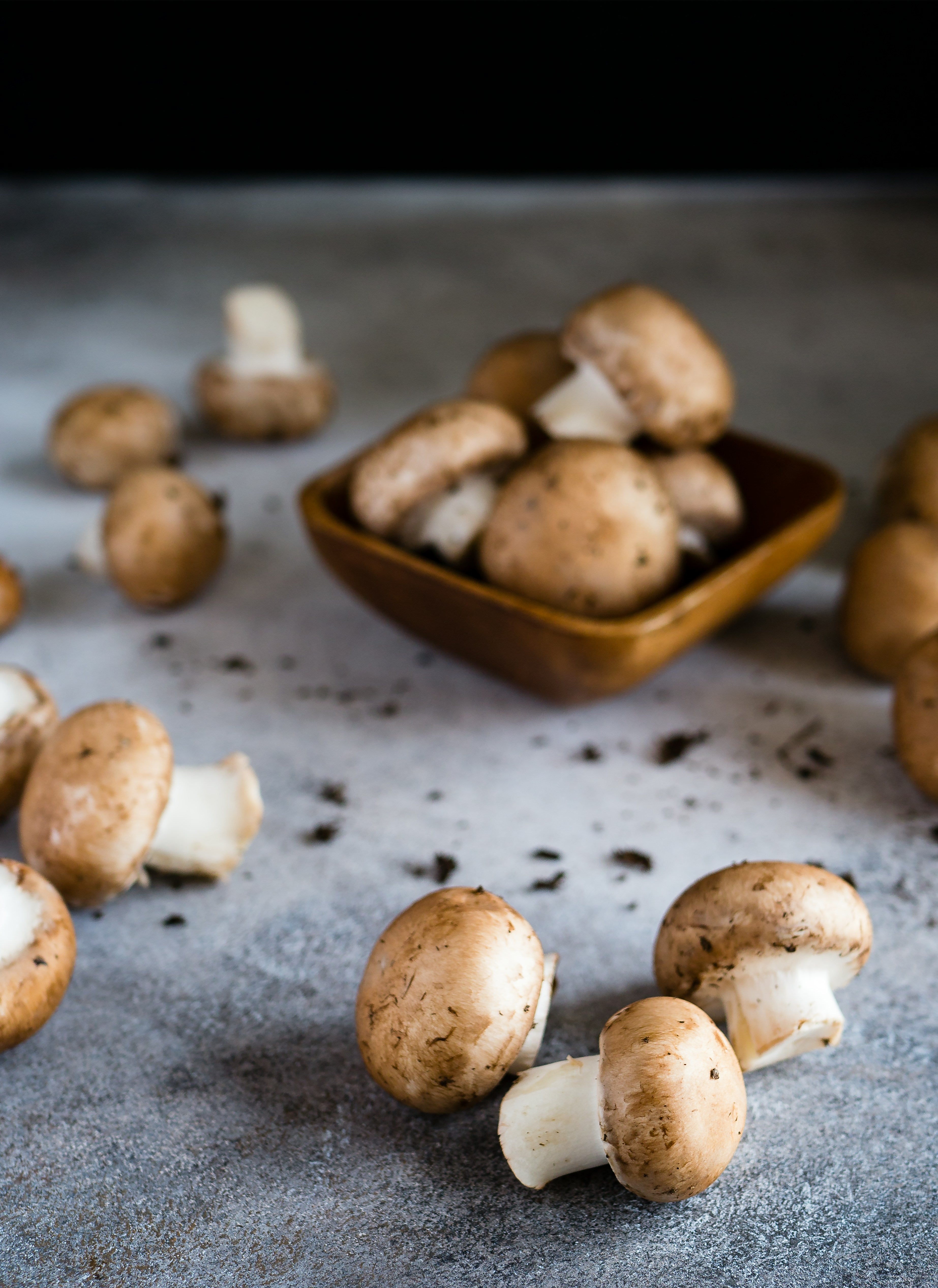 Button mushrooms on a kitchen worktop